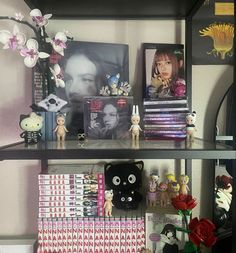 a shelf filled with lots of books and stuffed animals on top of it's shelves