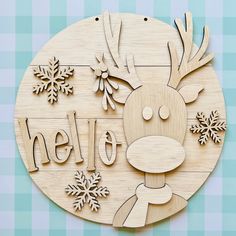 a wooden sign that says hello with a reindeer face and snowflakes on it