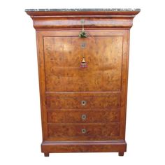 an old wooden chest with drawers and knobs