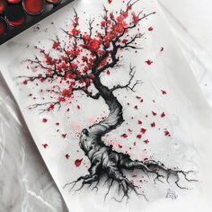 a drawing of a tree with red leaves on it next to some paintbrushes