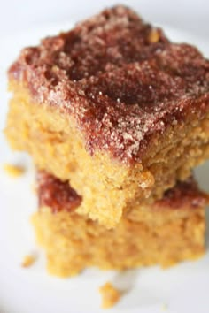 two pieces of cake sitting on top of a white plate with powdered sugar over them