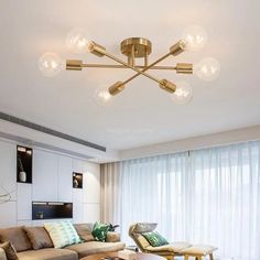 a living room filled with furniture and lots of lights on the ceiling over it's windows