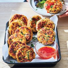 some food is sitting on a tray and ready to be eaten with dipping sauces