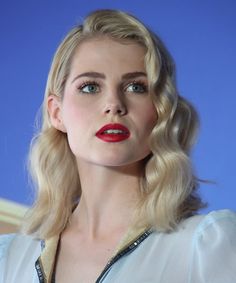 a woman with blonde hair and red lipstick