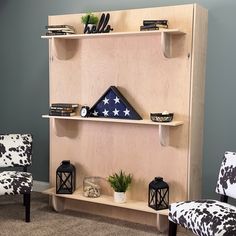 a living room with two chairs and a shelf