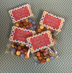 three bags filled with candy sitting on top of a table