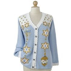 a mannequin wearing a blue and white cardigan with gold stars on it