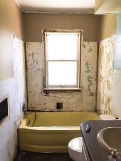 a bathroom that is being remodeled with paint on the walls and in the bathtub