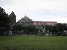 an old building with a large glass roof in the middle of it's yard