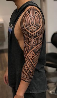 a man's arm with an intricate tattoo design on the back of his body