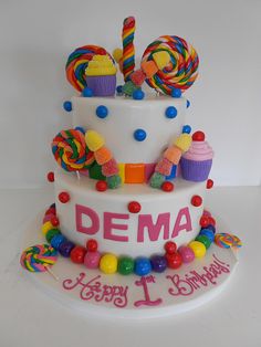 a birthday cake decorated with candies and lollipops