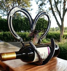 a wine bottle holder shaped like a heart