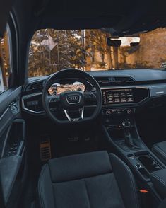 the interior of an audi car with dashboard, steering wheel and center console in front of it