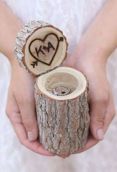 someone holding a piece of wood that has been carved into the shape of a heart