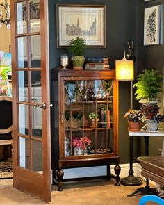 a living room filled with furniture and plants