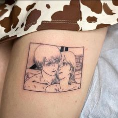 a woman with a tattoo on her thigh has a picture of two people in it