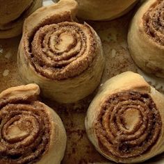 several cinnamon rolls are on a baking sheet and ready to be baked in the oven