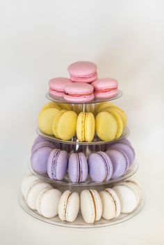 three tiered trays filled with different colored macaroons