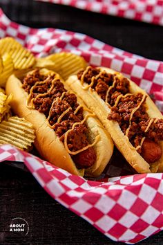 two chili cheese dogs with french fries on the side