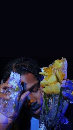 a woman holding flowers in front of her face