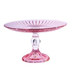 a pink glass cake plate sitting on top of a table