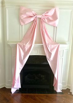 a fireplace with a pink bow on it