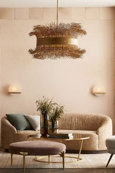 a living room filled with furniture and a chandelier hanging over the top of it