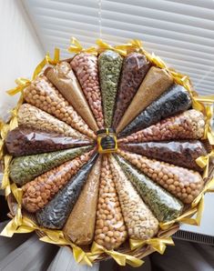 a person holding a tray filled with different types of beans and other foods in it