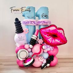 there is a pink and blue display with lipstick, nail polishes, and other items