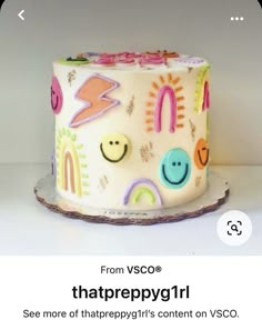 a white cake with colorful designs on it