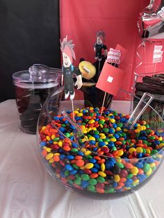 a bowl filled with lots of candy on top of a table