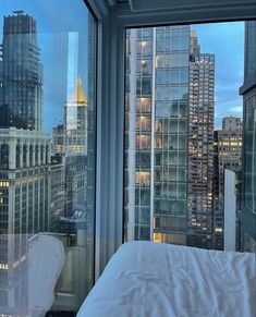 a bedroom with a view of the city at night