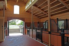 the inside of a stable with wooden walls and doors