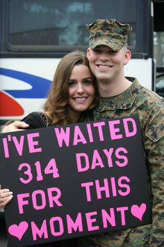 a man and woman holding a sign that says i've waited 31 days for this moment