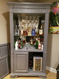 a cabinet filled with liquor bottles and glasses