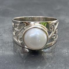 Solid 925 sterling silver fresh water Pearl ring with filigree design band, handmade and fair trade Natural Pearl Weight - Dimensions - L x B x H cm L x B x H inch Ring size - U.K. - U.S. - E.U. - Band width - Post - royalmail recorded Hallmarked Sterling Silver Pearl Ring, Silver Sterling Pearl Ring, White Moonstone Ring With Intricate Design, Silver Sterling Silver Pearl Ring, White Moonstone Ring With Intricate Design For Gift, Classic Adjustable Sterling Silver Filigree Ring, White Pearl Ring With Intricate Design For Gift, White Pearl Ring With Intricate Design As Gift, White Sterling Silver Hallmarked Pearl Ring