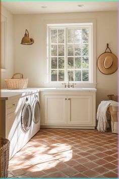 a washer and dryer sitting in a room next to a window with sun coming through