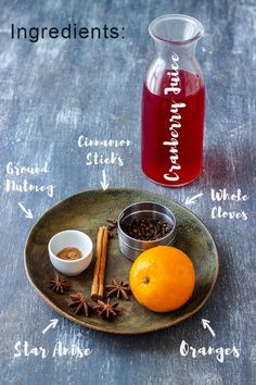 an orange, cinnamon sticks, and star anise sit on a plate with ingredients labeled