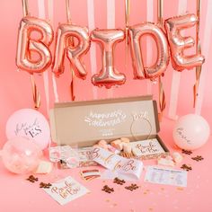 balloons, confetti and streamers on a pink background with the word bride spelled out