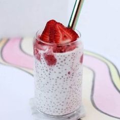 a strawberry and chia seed pudding in a glass with a straw