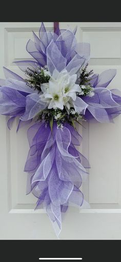 a purple and white wreath on the front door