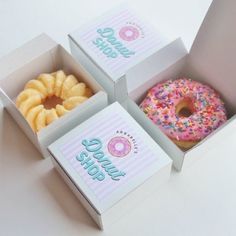 three donuts with sprinkles and frosting are in the same box