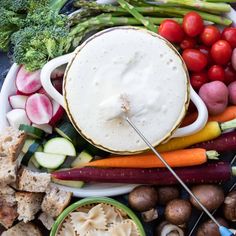 a platter filled with vegetables and dip