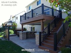 an outdoor living area with stairs and grill