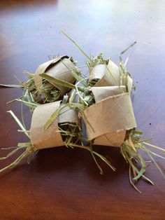 several rolls of toilet paper sitting on top of a wooden table next to some grass