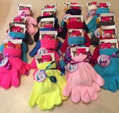 many different colored gloves are on the table