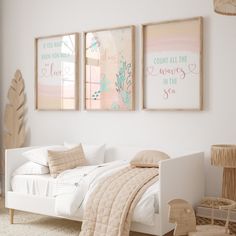 a bedroom with three framed pictures on the wall