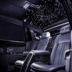 the interior of a limo with black leather seats and stars in the sky on the ceiling