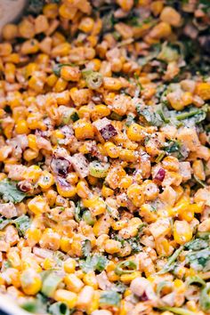 a bowl filled with corn and vegetables on top of a table