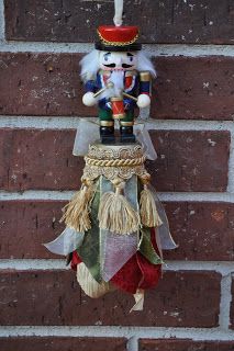 a nutcracker hanging from the side of a brick wall